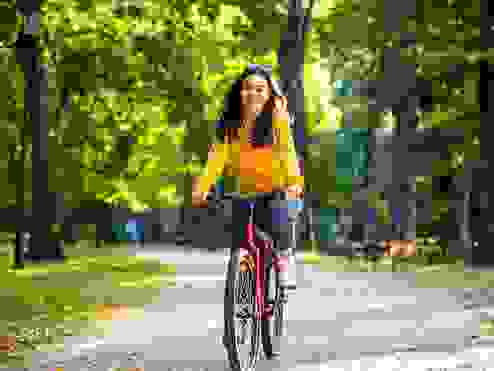 Women in a yellow top riding a bike